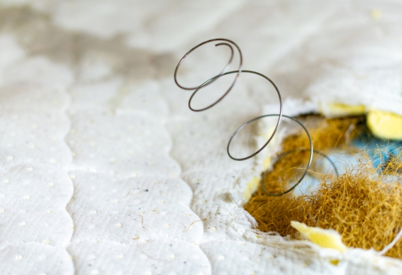 How To Dispose Of A Mattress- a spring poking through a mattress