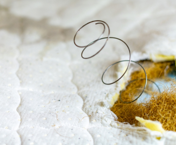 How To Dispose Of A Mattress- a spring poking through a mattress