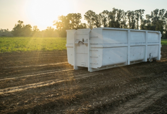 White container in a field