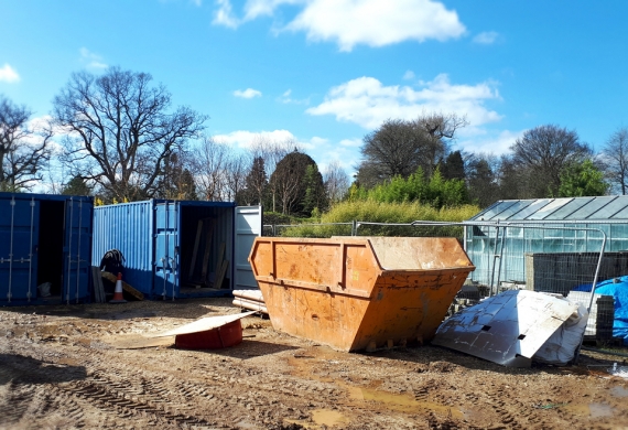 Skip Hire and Commercial Services- skips and containers on a muddy field