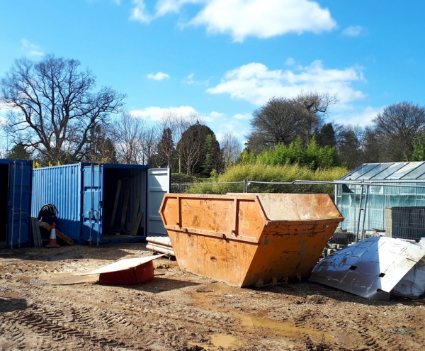 Skip Hire and Commercial Services- skips and containers on a muddy field