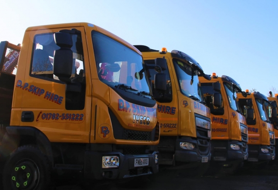 A line up of DP Skip Hire trucks