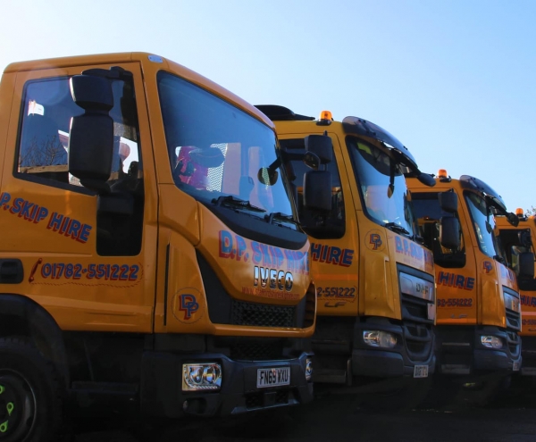 A line up of DP Skip Hire trucks