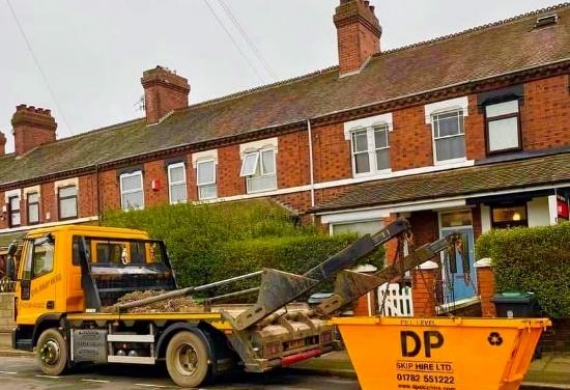 DP Skip Hire branded skip outside a home