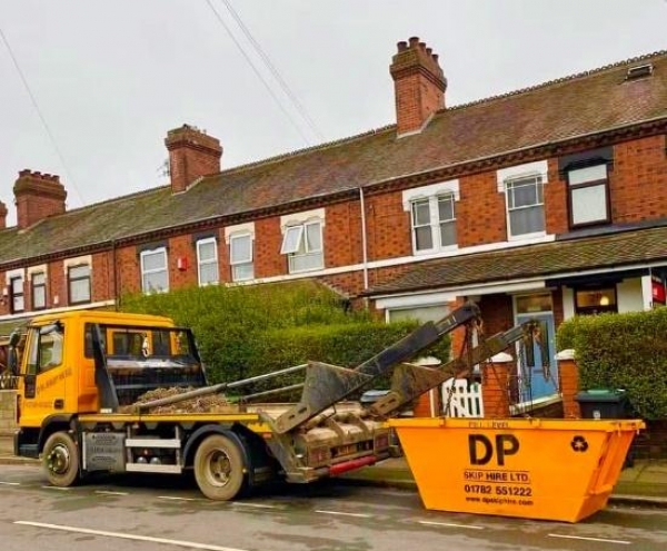 DP Skip Hire branded skip outside a home