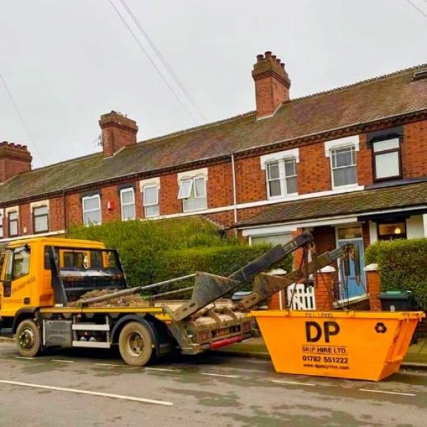 DP Skip Hire branded skip outside a home